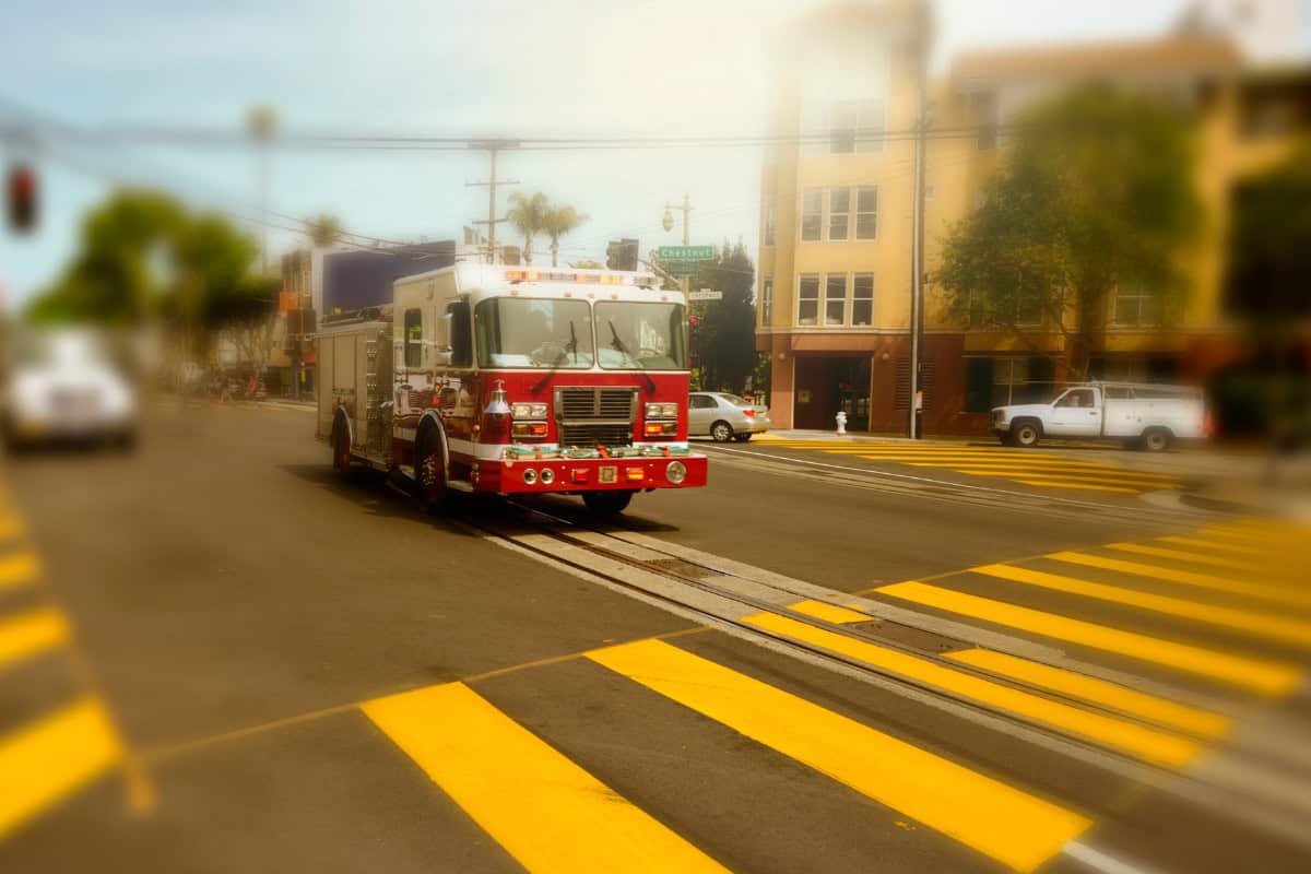 Image of a fire truck racing to a fire pit accident.