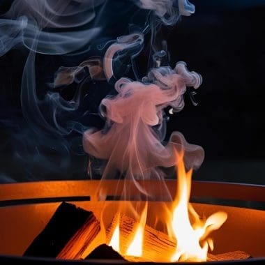 Image of a fire pit burning at night for a blog post covering how to put out a fire pit.