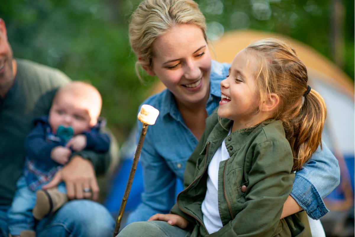 Image of a family with young children roasting marshmallows.