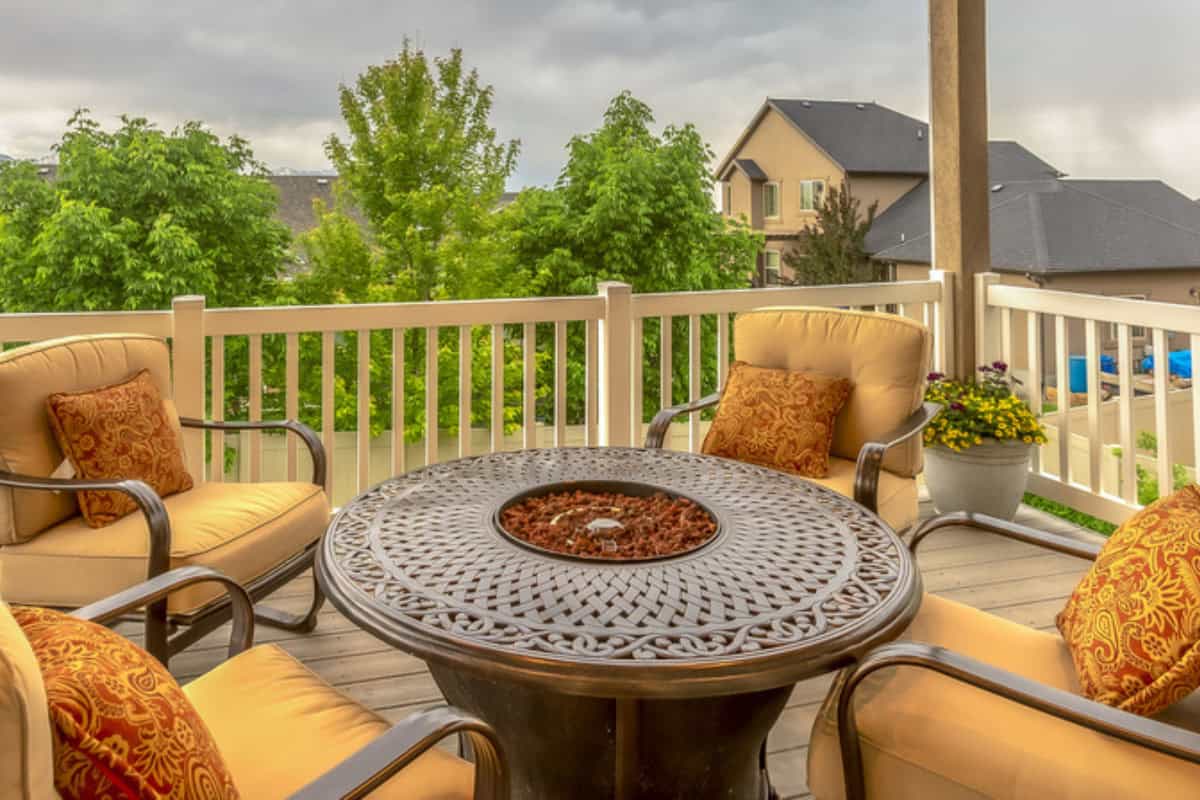 Image of a large round propane fire pit on a balcony.