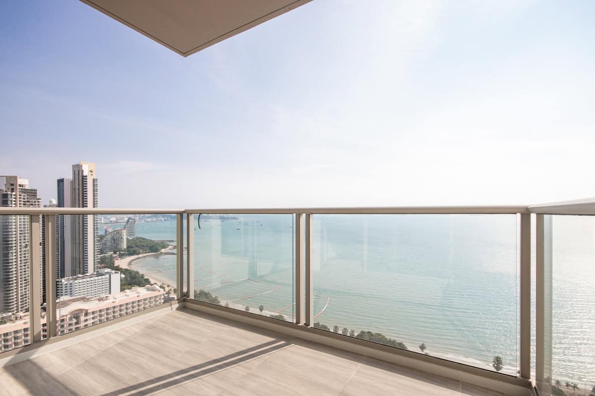 Image of a high rise balcony overlooking water for a blog post about using a fire pit on a balcony.