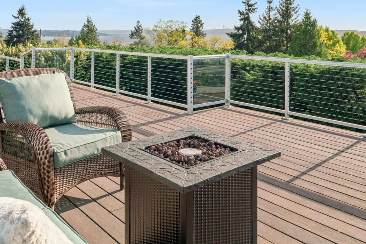 Image of a square propane fire pit on a composite deck balcony.