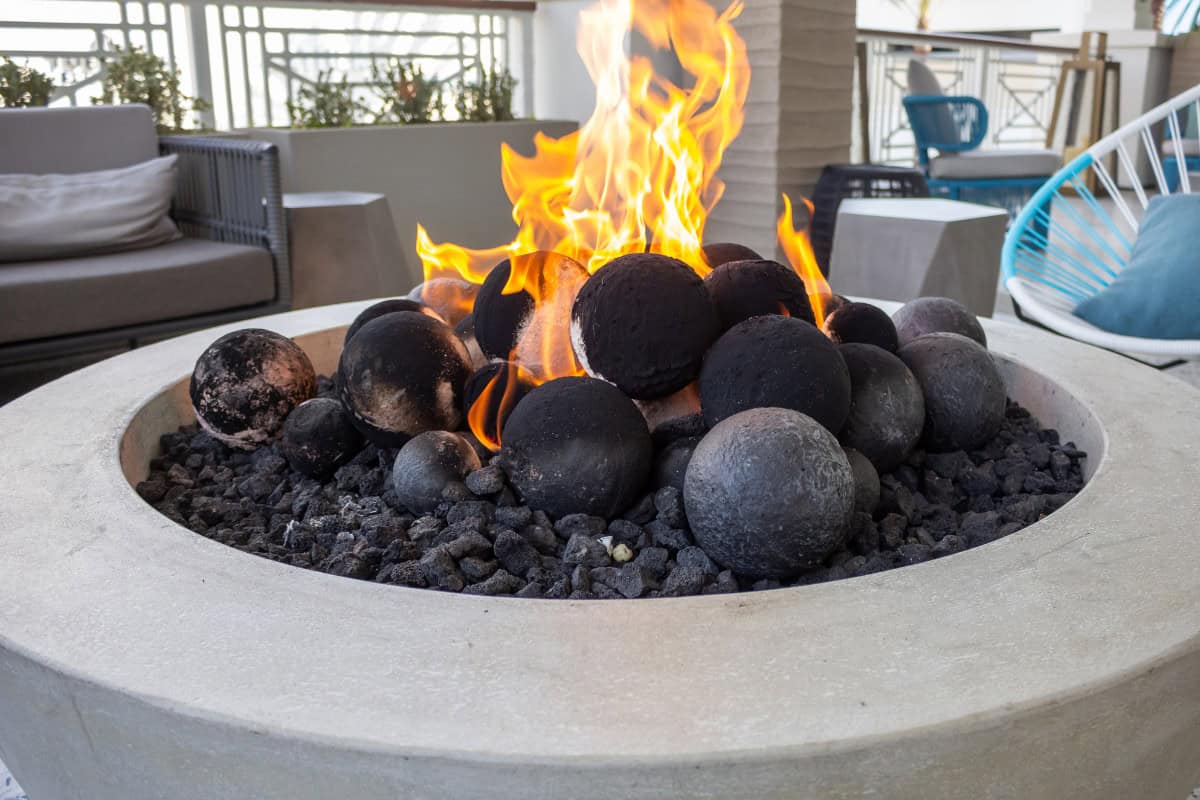 Image of a large gas fire pit bowl for a post covering the use of a fire pit on a balcony.