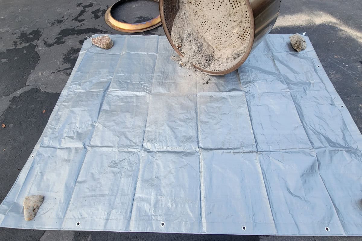 Image of a fire pit having its ash removed.