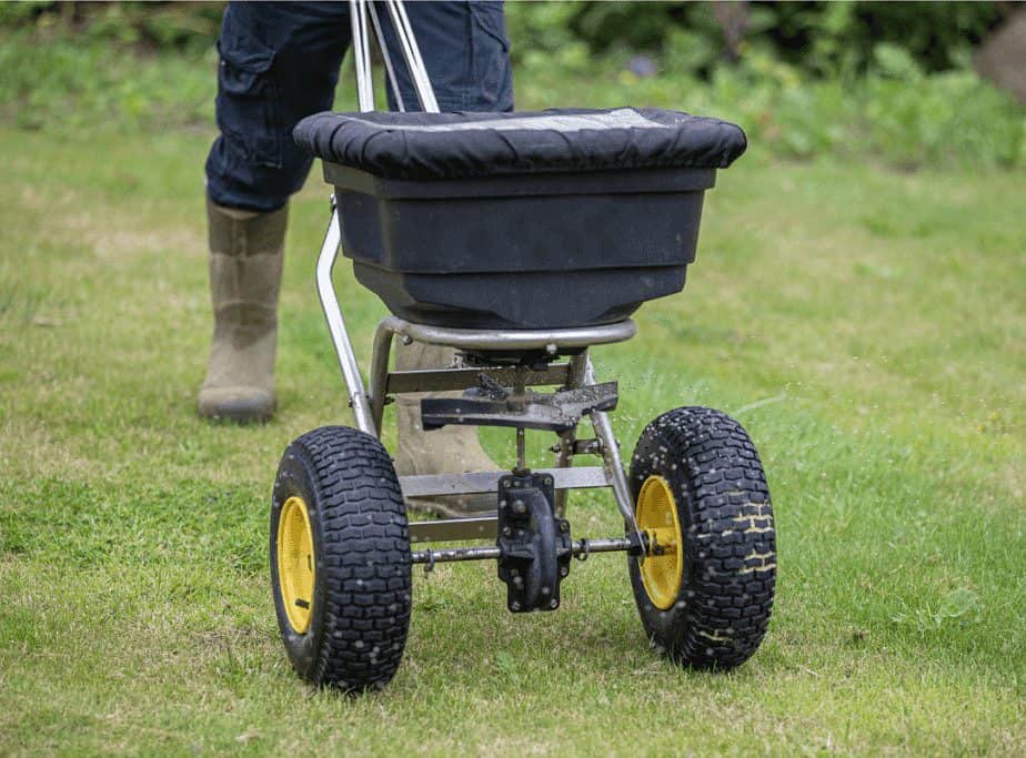 Image of fire pit ash being spread over a lawn