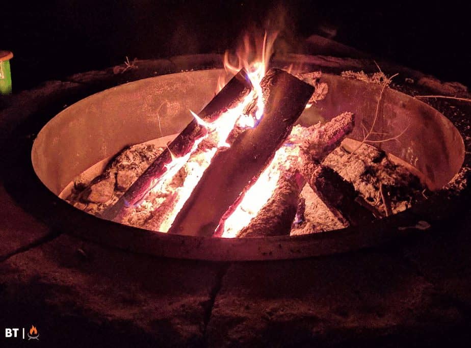 Image of a fire pit insert in a fire pit round at night