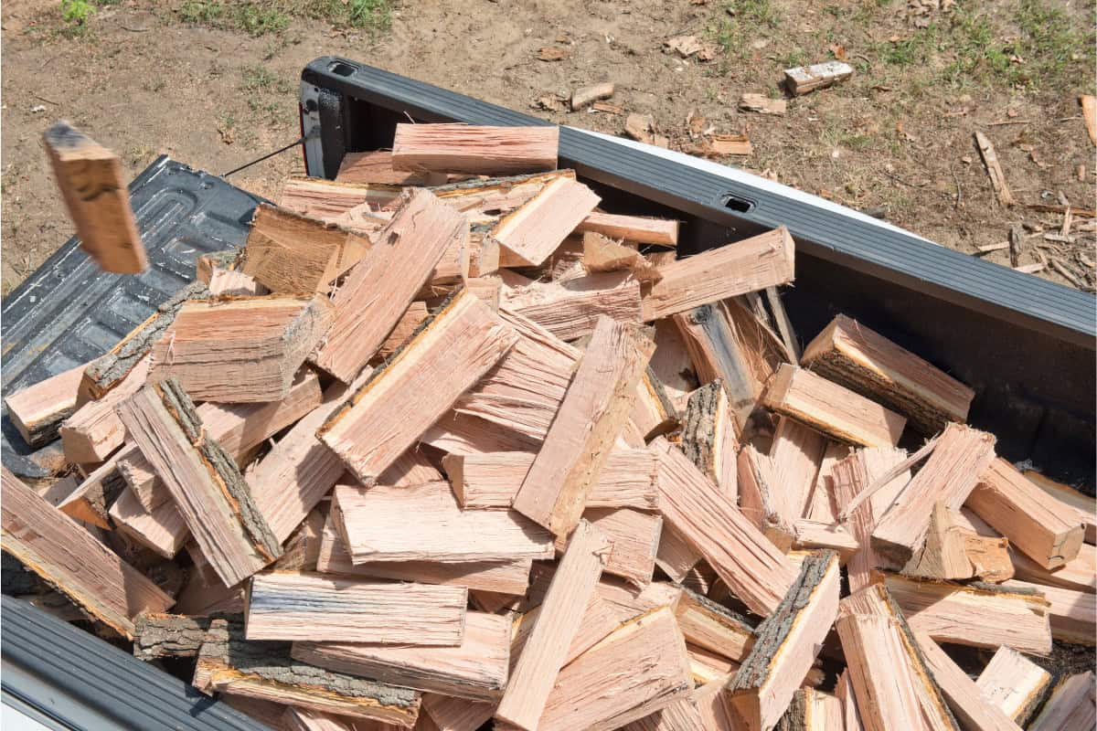 Image of firewood in the back of a pickup truck.