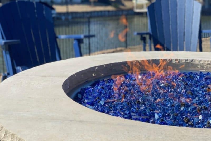 Image of a gas fire pit with blue glass for an article covering fire pit glass.