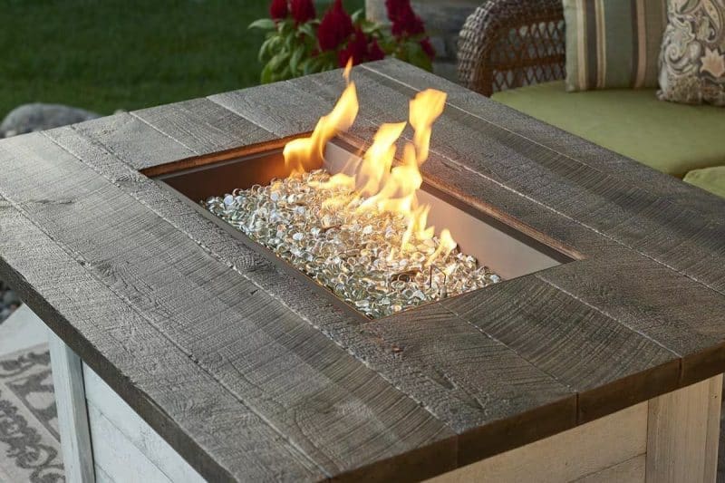Image of a burning rectangular propane fire pit for a blog post about gas fire pit whistles.
