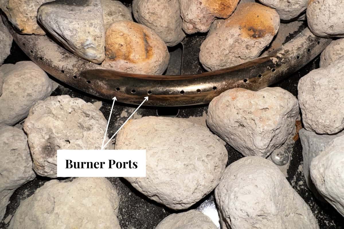 Image of the burner ports of a portable propane fire pit.