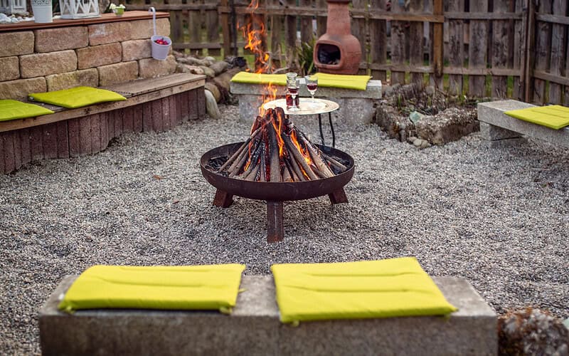 Image of a home's fire pit area for a fire pit terms page.