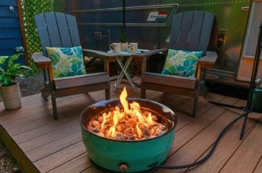 Image of a portable gas fire pit on composite decking for a blog post that answers the question, "how many fire pit btus do I need?"