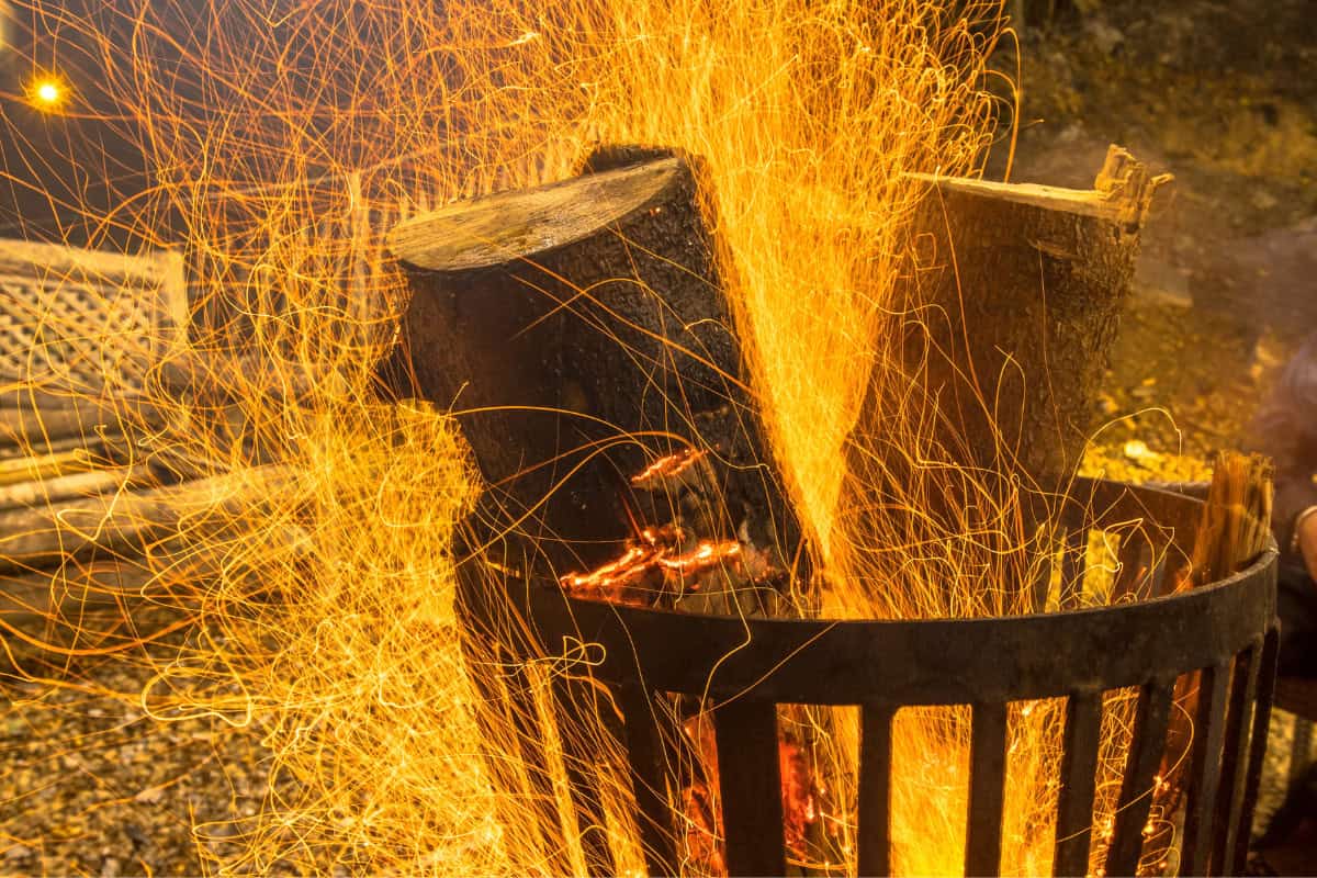 Rules and Permits for Fire Pit Usage Image of a fire pit burning with sparks.