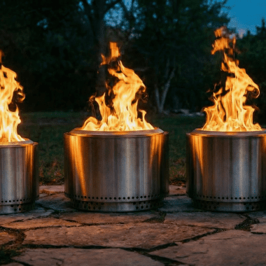 Image of a row of Solo Stove fire pits burning at dusk for a blog post that answers the question, "what size Solo Stove should I buy?"