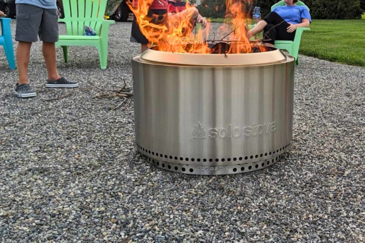 Stainless steel outdoor fire pit with flames, ideal for backyard gatherings and cozy evenings. Perfect for adding warmth and ambiance to your backyard oasis.