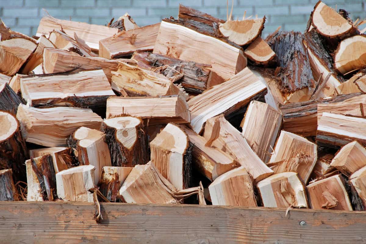Image of a a pile of chopped firewood in the back of a delivery truck.