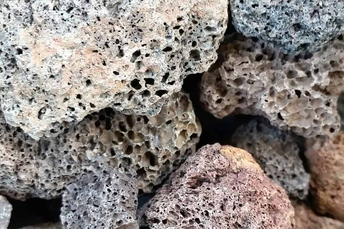 Porous volcanic rocks used for backyard fire pits and outdoor heating, providing a rustic and natural aesthetic for outdoor living spaces.