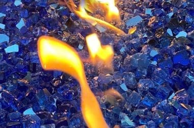 Image of blue fire glass in a fire pit for a blog pit on how to clean fire glass.