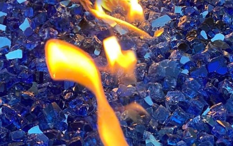 Image of blue fire glass in a fire pit for a blog pit on how to clean fire glass.