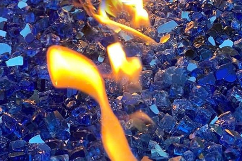 Image of blue fire glass in a fire pit for a blog pit on how to clean fire glass.