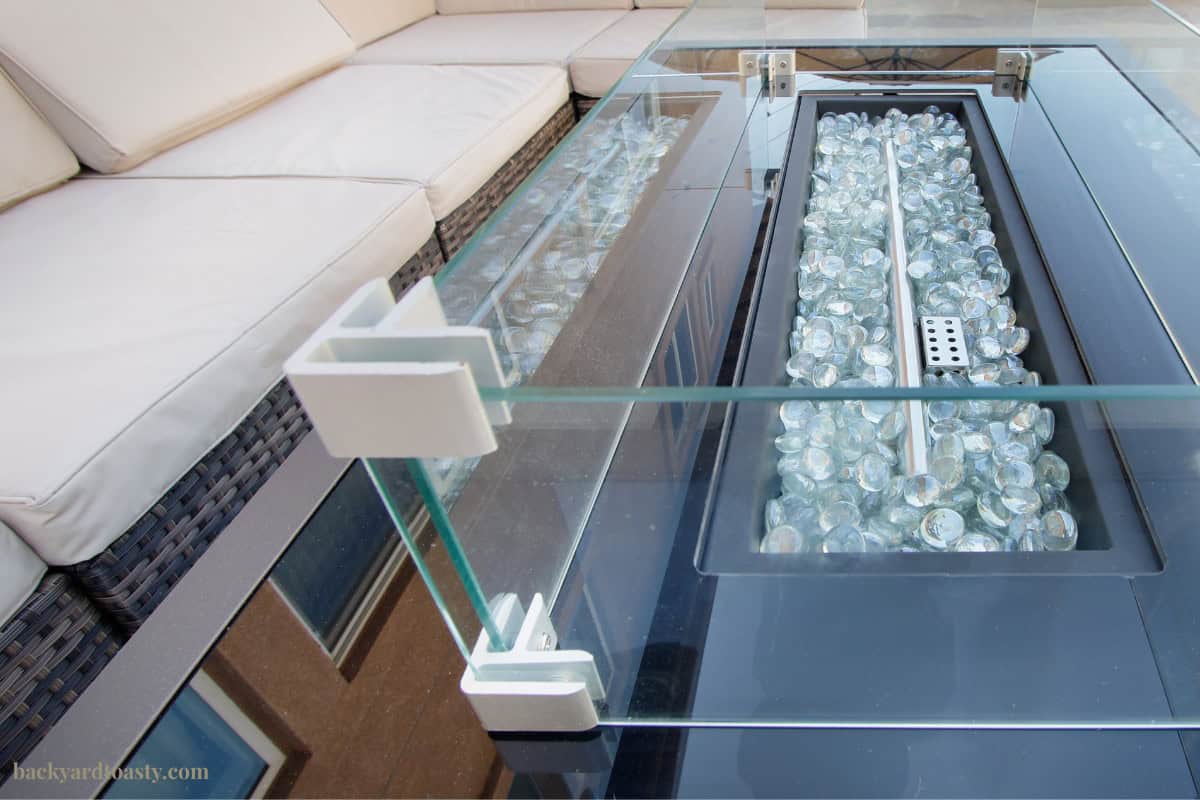 Image of clean, well maintained gas fire pit with seating for a blog post covering how to measure for a fire pit cover.