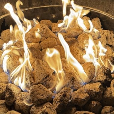 Image of a burning gas fire pit at night for a product review of the Outland Living Mega portable gas fire pit.