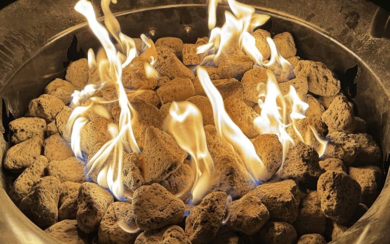 Image of a burning gas fire pit at night for a product review of the Outland Living Mega portable gas fire pit.