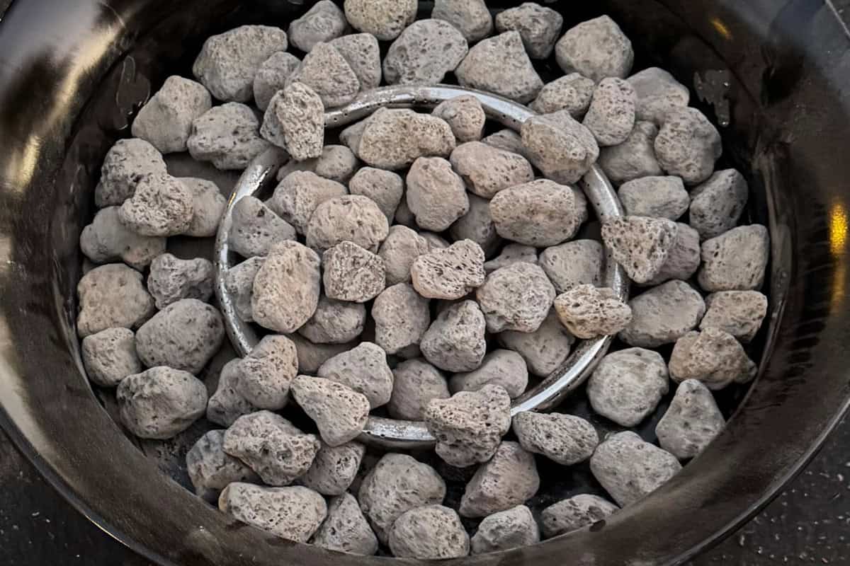 outland-living-mega-fire-pit-review-main Image of lava rock in a gas fire pit from above.