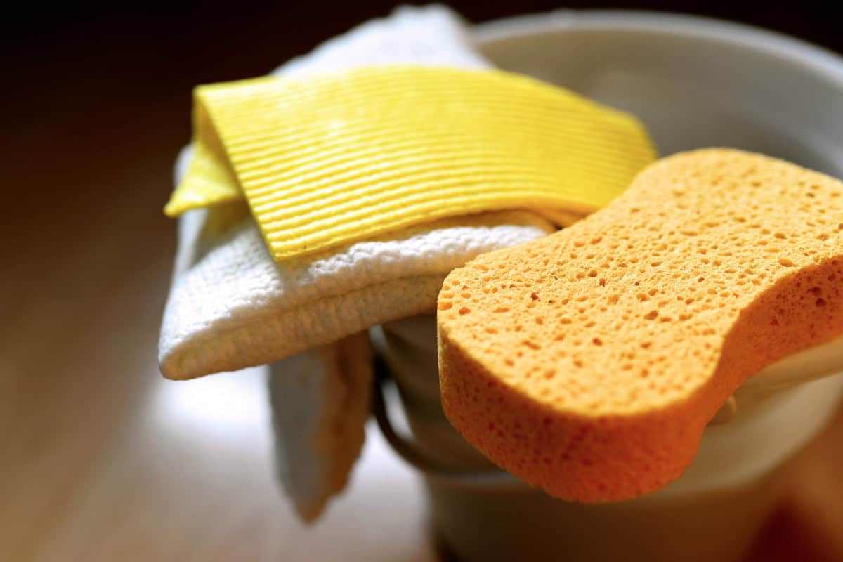 outland-living-mega-fire-pit-review-maintenance Image of a bucket with a sponge and a washcloth.