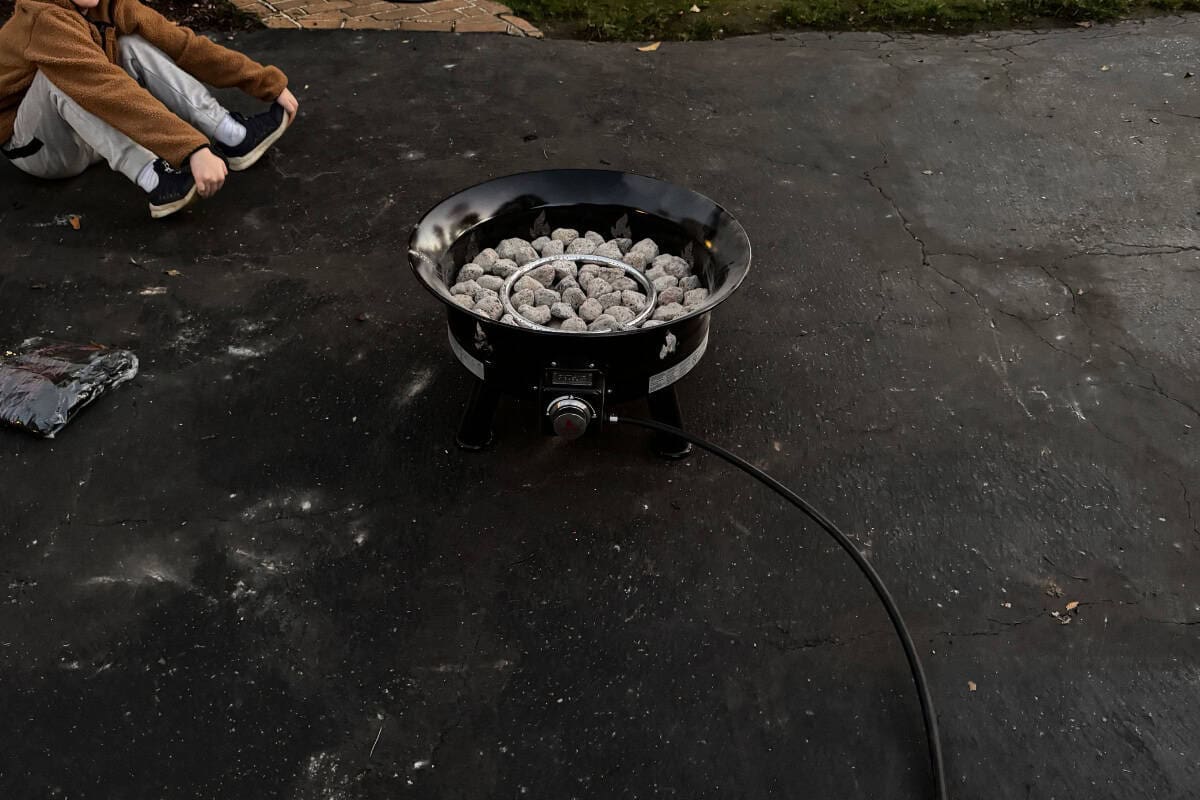 outland-living-mega-fire-pit-review-safety Image of a new Outland Mega fire pit on a driveway.