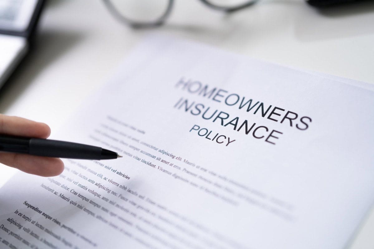 Image of a persion looking over the terms of a homeowners insurance policy.