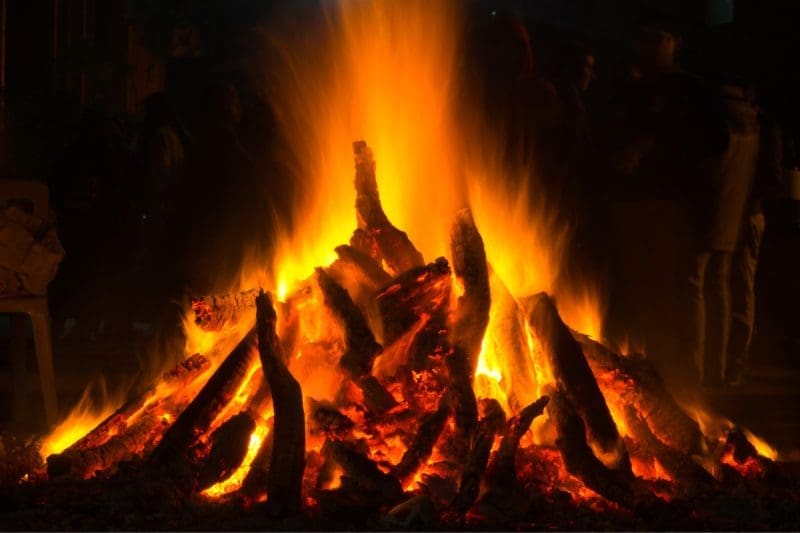 Image of a fire at an fire festival in India for a blog post covering fire pit history.