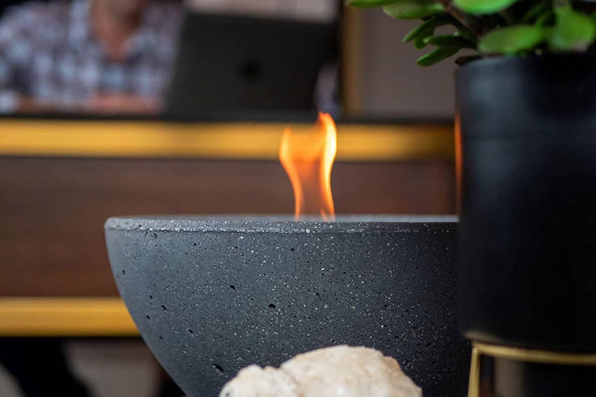 Image of a tabletop gel-fuel fire pit on a table.
